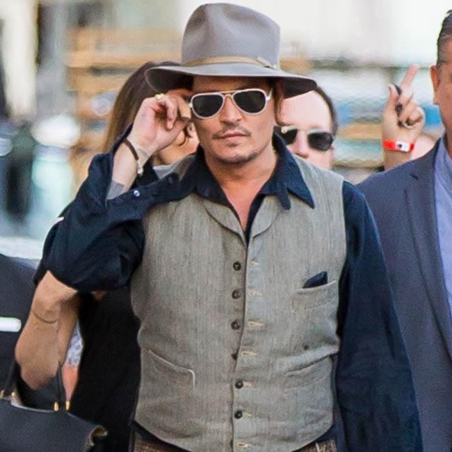 Johnny Depp pauses to smoke cigar and greet fans